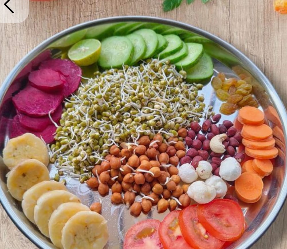 Healthy sprouts and salad bowl with moong, chana, vegetables, and dry fruits